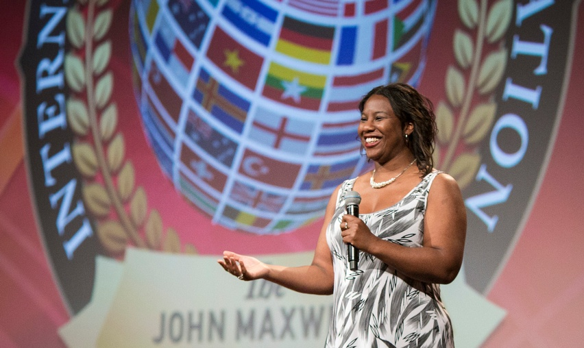 Olive Pellington speaking at a John Maxwell International event