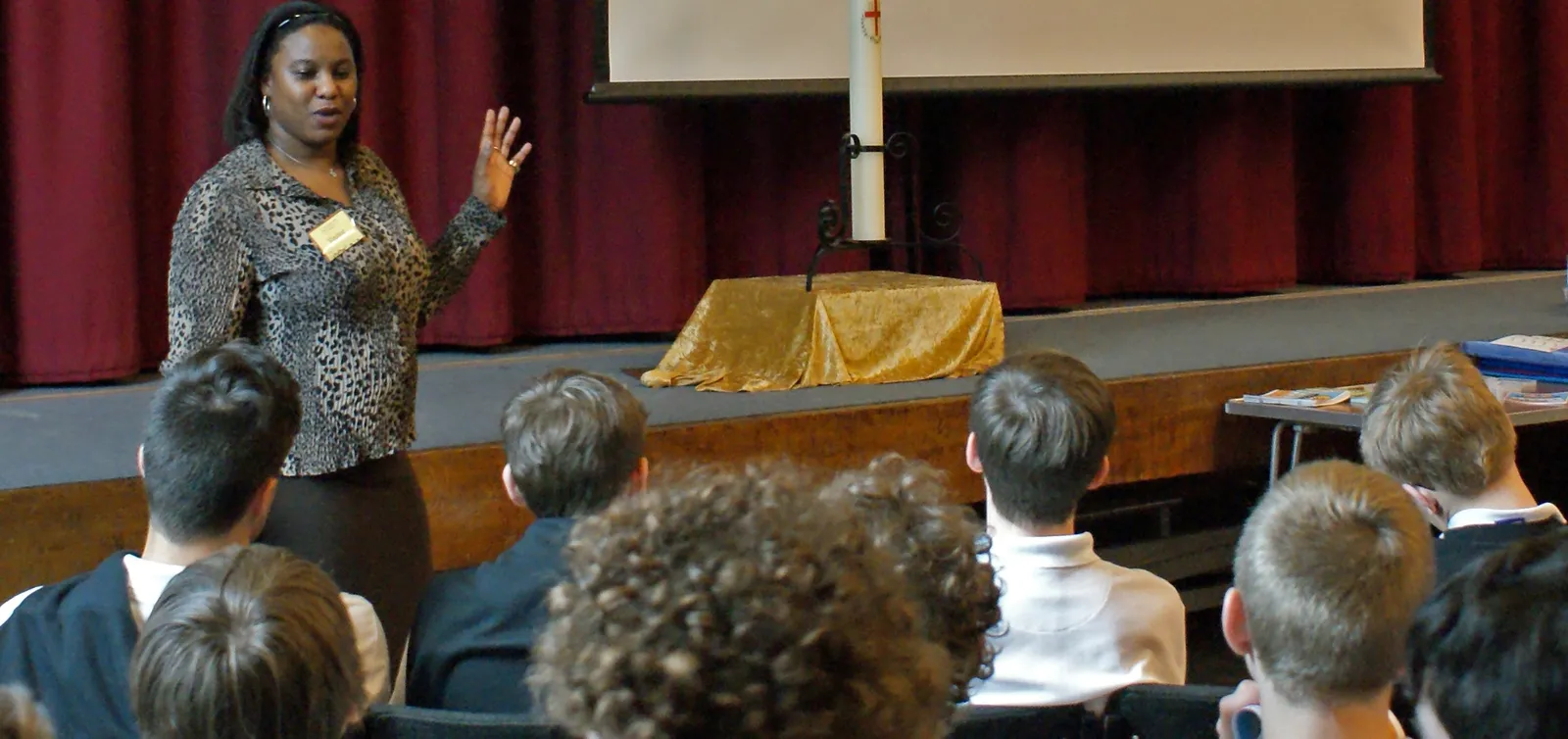 Olive Pellington speaking to a school assembly of students